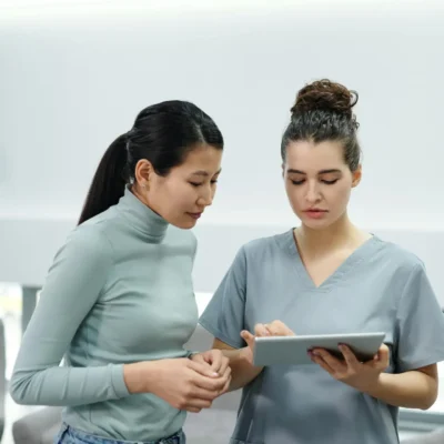 A Doctor and a Patient Looking at a Tablet